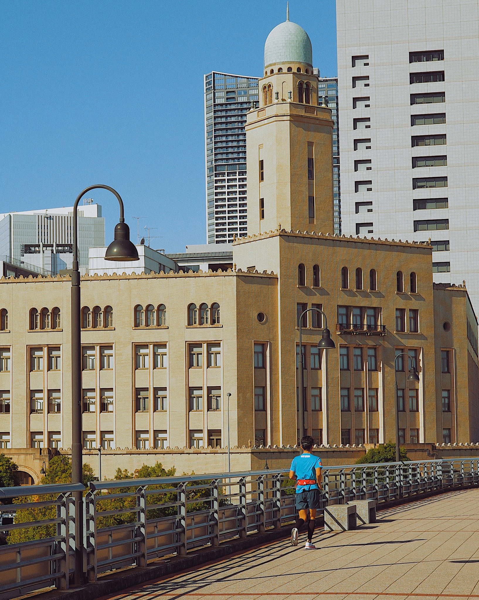 Person jogging with historic Yokohama buildings in background on a clear morning.