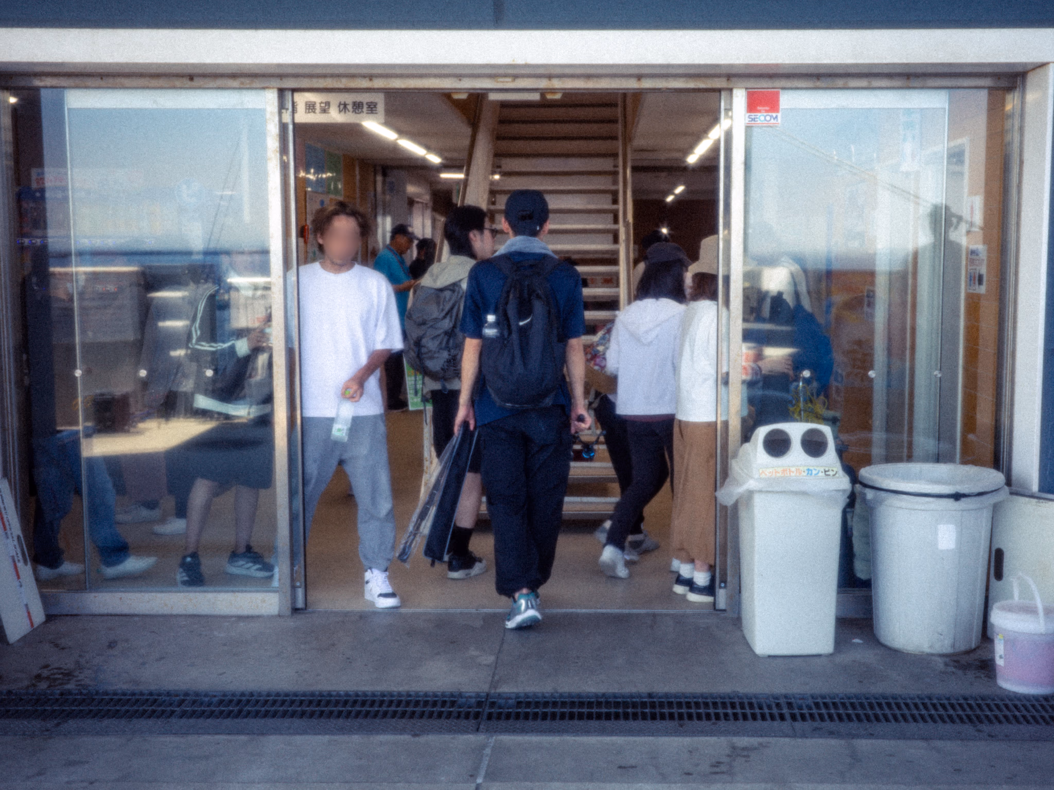 Anglers passing through the Honmoku Pier entrance doors.